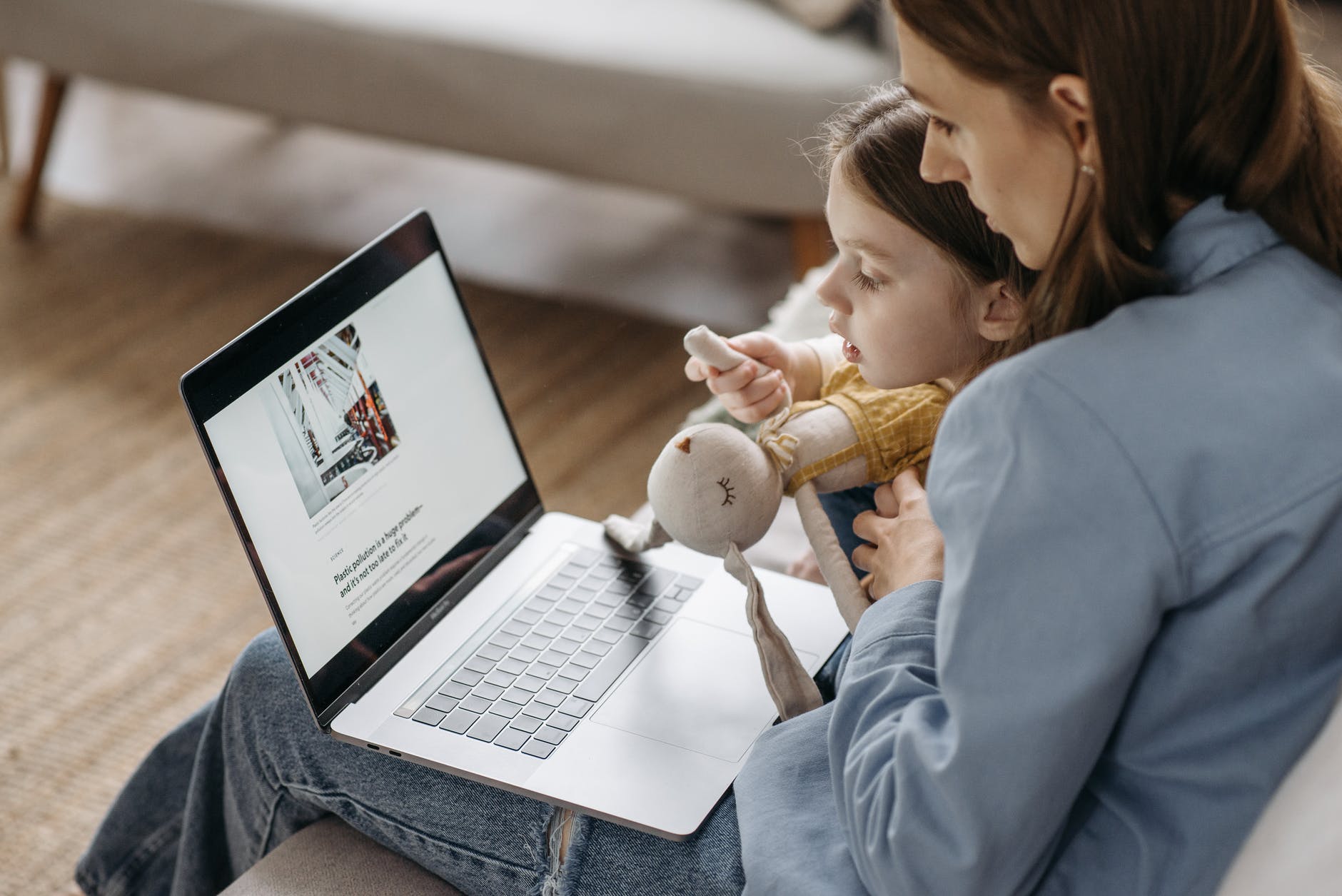 woman using a laptop with her daughter
